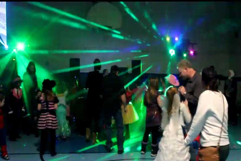 School Light Show, Hamilton DJ, Family Dance, guests dancing with laser beams & special  effects beams  everywhere, Green beams of light fill the gym.  Taken in Hamilton.